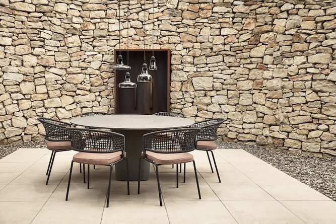 Shadows Exterior Pendelleuchten über einem runden Tisch im steinernen Innenhof